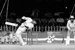 Kapil Dev of India ducks a bouncer during his innings of 43 runs in the 2nd Test match between Pakistan and India at Gaddafi Stadium, Lahore, Pakistan, 1st November 1978. The fielder for Pakistan is Majid Khan. Pakistan won the match by 8 wickets. (Photo by Patrick Eagar/Popperfoto via Getty Images)